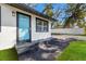 Close up of the front door with a bright blue finish and well-kept front yard at 8501 N Alaska St, Tampa, FL 33604