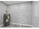 Utility Room with water heater, gray paint, and vinyl flooring at 8501 N Alaska St, Tampa, FL 33604