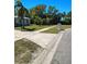 Well-maintained front yard with a long driveway leading to a single-story home at 8588 95Th Ave, Seminole, FL 33777