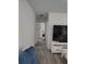 Bright hallway featuring clean white walls and modern gray wood flooring at 8588 95Th Ave, Seminole, FL 33777