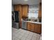 Well-equipped kitchen with stainless steel appliances, wood cabinets, and granite countertops at 8588 95Th Ave, Seminole, FL 33777