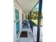 Cozy porch with seating and a welcoming entrance to the home at 8588 95Th Ave, Seminole, FL 33777