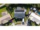 Aerial view of the property with a solar panel roof and a well-kept backyard at 8918 Country Square Dr, Seminole, FL 33777