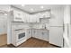 Well-lit kitchen with white cabinets, modern appliances, and beautiful countertops at 9025 Gronde Ave, Brooksville, FL 34601