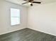 Bedroom featuring modern flooring, neutral walls, and a ceiling fan for added comfort at 9056 Iron Oak Ave, Tampa, FL 33647