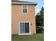 Close-up of the exterior of the property showing the siding and sliding glass door at 9056 Iron Oak Ave, Tampa, FL 33647