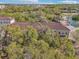 Aerial view of complex surrounded by mature trees and a small pond at 958 Sombra St, Tampa, FL 33619