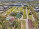 Expansive aerial view of a neighborhood with lake, pool, and community amenities at 958 Sombra St, Tampa, FL 33619