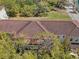 Aerial view of complex with tile roofs, balconies, and lush landscape at 958 Sombra St, Tampa, FL 33619