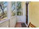 Cozy balcony with terra cotta tiles, white railing, and view of lush foliage at 958 Sombra St, Tampa, FL 33619