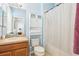 Bathroom with single sink vanity, and toilet with linen closet, offering practical functionality at 958 Sombra St, Tampa, FL 33619