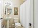 Well-lit bathroom with a pedestal sink and shower with curtain at 958 Sombra St, Tampa, FL 33619