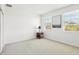 Bright bedroom with two windows and a bedside table with lamp at 958 Sombra St, Tampa, FL 33619