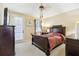 Bedroom with a sliding glass door, dark wood furnishings, ceiling fan and neutral color scheme, providing a cozy retreat at 958 Sombra St, Tampa, FL 33619