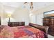 Bedroom featuring dark wood furnishings, a ceiling fan, and closet doors, offering a relaxing retreat at 958 Sombra St, Tampa, FL 33619