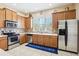 Modern kitchen featuring wooden cabinets, stainless steel appliances, and a bright window view at 958 Sombra St, Tampa, FL 33619
