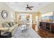 Open-concept living room with wood floors, a ceiling fan, and a view into the kitchen at 958 Sombra St, Tampa, FL 33619