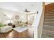 Cozy living room featuring hardwood floors, archway to kitchen and staircase at 958 Sombra St, Tampa, FL 33619