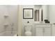 Bright bathroom featuring a shower-tub combo, toilet, vanity, decorative wall art, and white cabinets at 10209 Purple Leaf Ct, Riverview, FL 33578