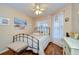 Charming bedroom with a metal frame bed, hardwood floors, plenty of natural light, and a ceiling fan at 10222 Woodford Bridge St, Tampa, FL 33626