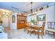 Dining room area with tile floors, furniture, and decorative hutch at 10222 Woodford Bridge St, Tampa, FL 33626