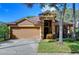 Charming single Gathering home featuring a two-car garage, well-maintained lawn, and manicured landscaping at 10222 Woodford Bridge St, Tampa, FL 33626