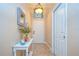 Welcoming hallway featuring tiled floors, a decorative table with flowers, and neutral wall colors at 10222 Woodford Bridge St, Tampa, FL 33626