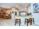 Charming eat-in kitchen with granite counters, tiled backsplash, breakfast bar, and seating for casual dining at 10222 Woodford Bridge St, Tampa, FL 33626
