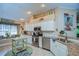 Bright kitchen with white cabinets, granite countertops, stainless steel appliances, and stylish decor at 10222 Woodford Bridge St, Tampa, FL 33626