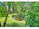 A tranquil pond is surrounded by manicured hedges and verdant foliage at 10222 Woodford Bridge St, Tampa, FL 33626