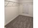 Walk-in closet featuring neutral carpet with adjustable wire shelving for ample storage and organization at 10630 Gable Dig Loop, San Antonio, FL 33576
