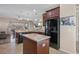 Bright kitchen featuring dark wood cabinets, an island, and a refrigerator at 11202 Wembley Landing Dr, Lithia, FL 33547