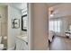 Bathroom featuring a toilet, sink, mirror, and bedroom view at 11308 Grandville Dr, Temple Terrace, FL 33617