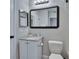 Bathroom with a granite vanity, framed mirror, white toilet, and gray walls at 11308 Grandville Dr, Temple Terrace, FL 33617