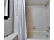 Bathroom features a white tiled shower and bathtub at 11308 Grandville Dr, Temple Terrace, FL 33617