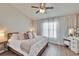 Bright bedroom featuring a ceiling fan, a large window with curtains, and a vanity at 11308 Grandville Dr, Temple Terrace, FL 33617