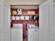 Closet featuring a washer, dryer, shelves, and ample storage space at 11308 Grandville Dr, Temple Terrace, FL 33617