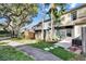 Exterior view of a townhome with well-maintained landscaping and a walkway at 11308 Grandville Dr, Temple Terrace, FL 33617