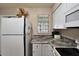 Compact kitchen with stainless steel appliances and ample counter space at 11308 Grandville Dr, Temple Terrace, FL 33617