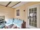 Covered porch with outdoor seating and a grill at 11308 Grandville Dr, Temple Terrace, FL 33617