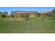 Backyard featuring a well-manicured lawn and a screened-in pool area at 12 Medalist Ter, Rotonda West, FL 33947