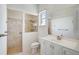 Bathroom with a large mirror, white cabinets, and a walk-in shower at 12 Medalist Ter, Rotonda West, FL 33947