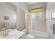 Bright bathroom with tub-shower combo, vanity and neutral finishes at 12 Medalist Ter, Rotonda West, FL 33947