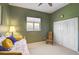 Relaxing green bedroom featuring cozy rocking chair and built in closet at 12 Medalist Ter, Rotonda West, FL 33947