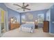 Cozy bedroom features carpet, ceiling fan, natural light, and serene blue walls at 12 Medalist Ter, Rotonda West, FL 33947