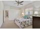 Comfortable bedroom featuring a ceiling fan and a window bringing in natural light at 12 Medalist Ter, Rotonda West, FL 33947