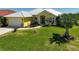 Charming one story home featuring a manicured front lawn and attached garage at 12 Medalist Ter, Rotonda West, FL 33947