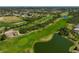 Aerial view of a lush golf course with a lake in a residential community at 12 Medalist Ter, Rotonda West, FL 33947