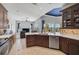 Well-equipped kitchen with wood cabinets, quartz countertops, seamlessly connecting to the dining and living spaces at 12 Medalist Ter, Rotonda West, FL 33947