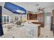 Open kitchen layout with an island, wood cabinets, and white counter tops adjacent to the dining and living areas at 12 Medalist Ter, Rotonda West, FL 33947